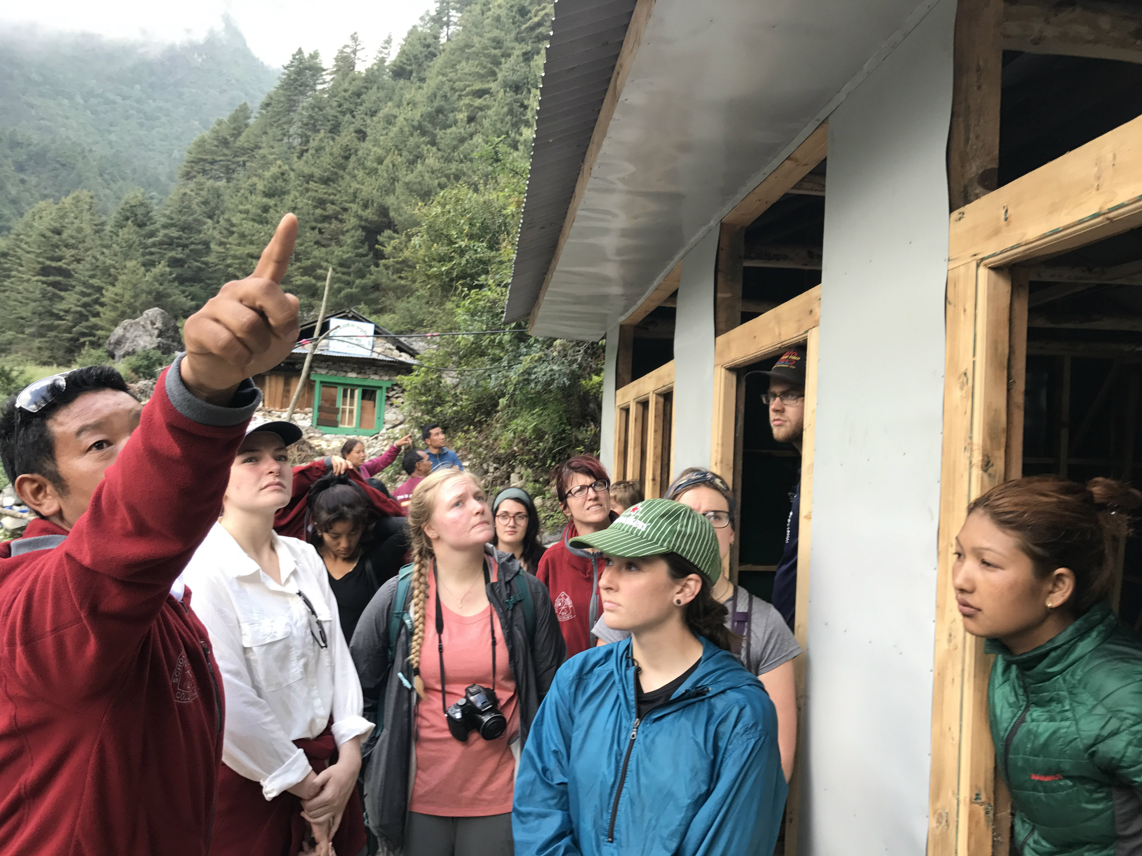 Lhakpa Sherpa, founder of Hike for Help, explains to Mines students the construction of Hike for Help's workshop for the Dalit to produce and sell their handicrafts .